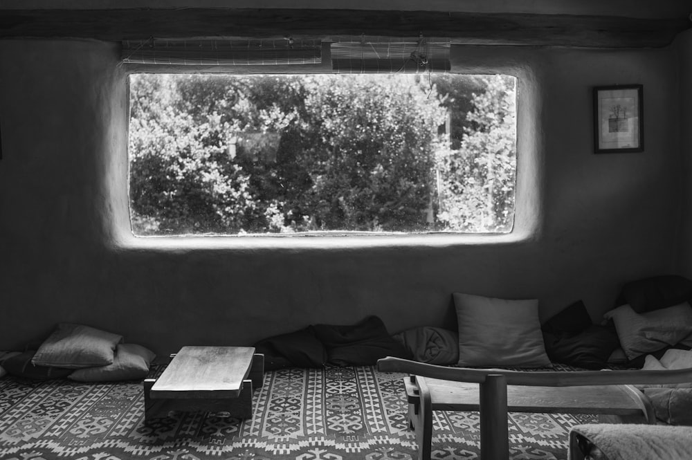 grayscale photo of black and white checkered textile on bed