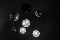 Creative lighting fixtures casting colorful patterns over an elegant event setup indoors.