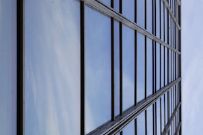 Close-up of a sparkling clean glass facade reflecting the blue sky