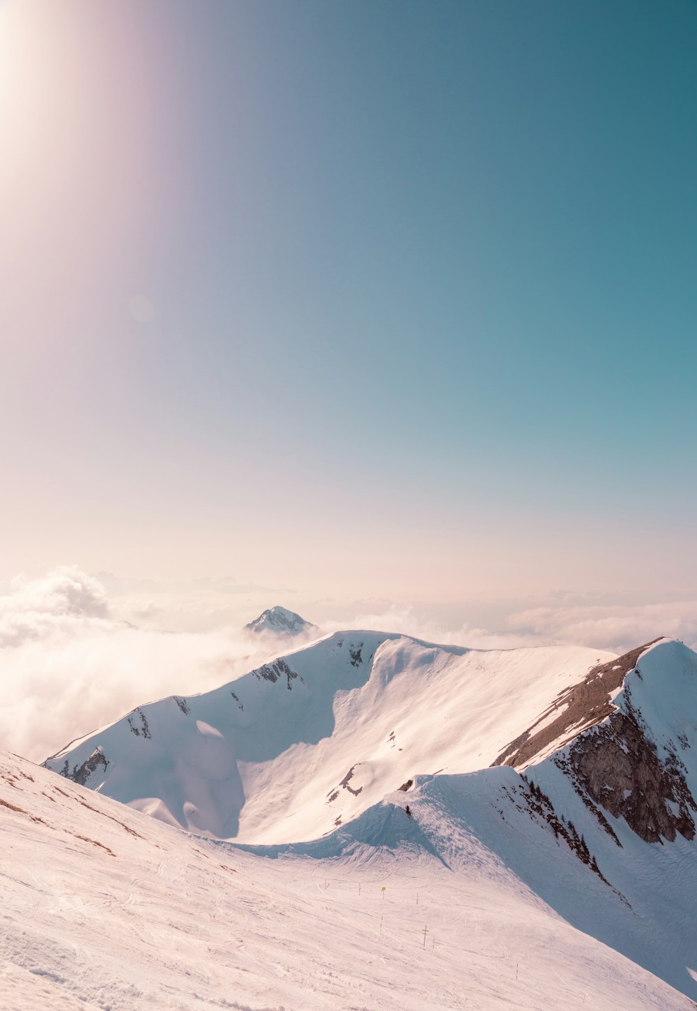 snow covered mountain under blue sky during daytime