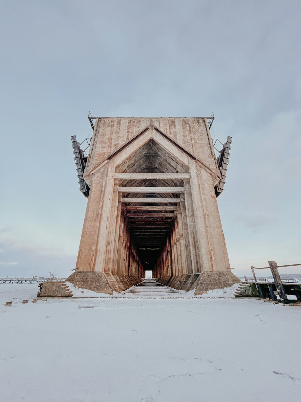 brown wooden bridge under white sky during daytime