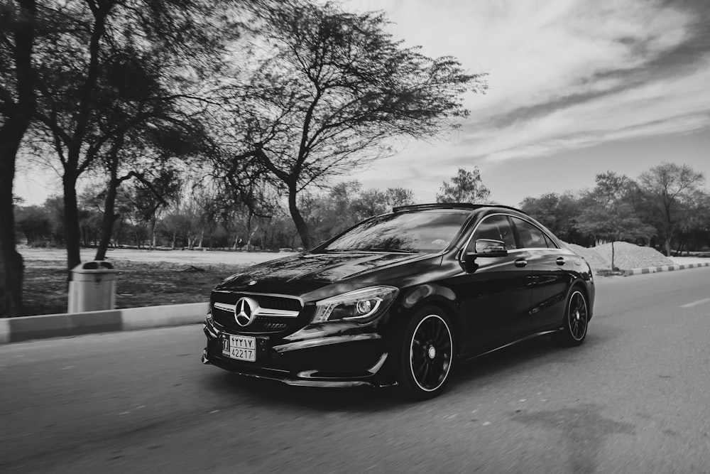 grayscale photo of black bmw m 3 coupe on road