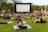 A vibrant event venue filled with people enjoying a film screening.
