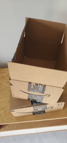 A customer unboxing a package filled with assorted ecommerce products.