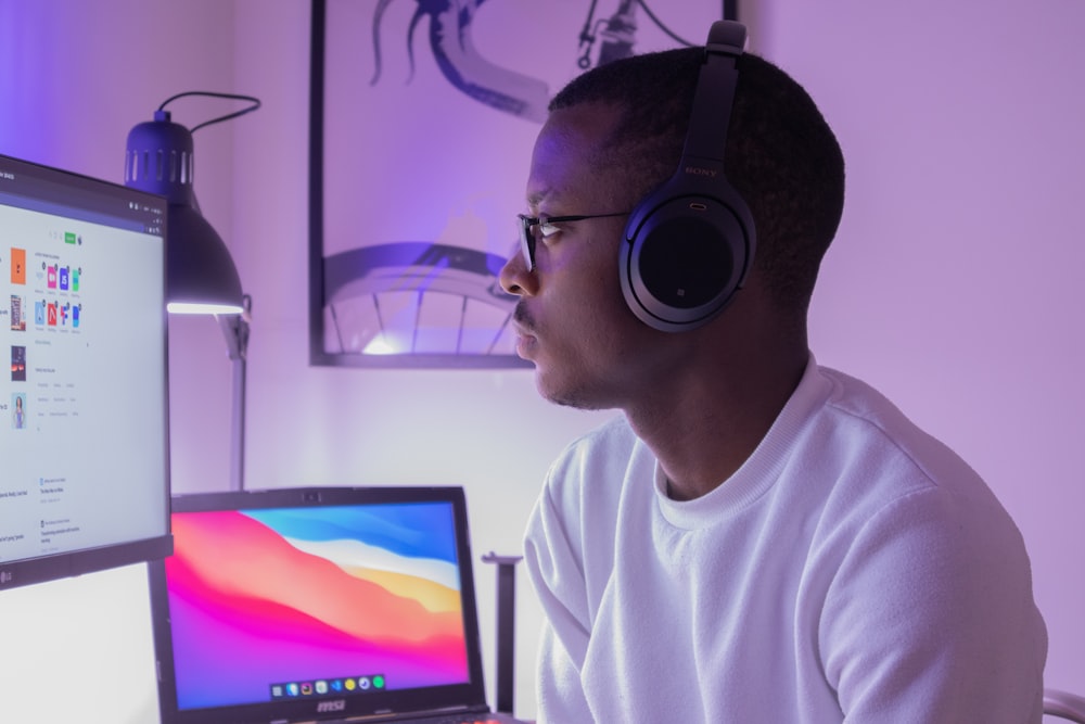 man in white crew neck shirt wearing black headphones