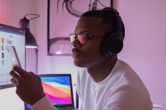 man in white crew neck shirt wearing black headphones