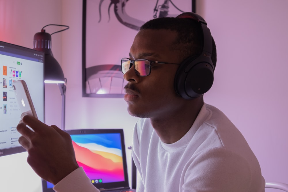 man in white crew neck shirt wearing black headphones