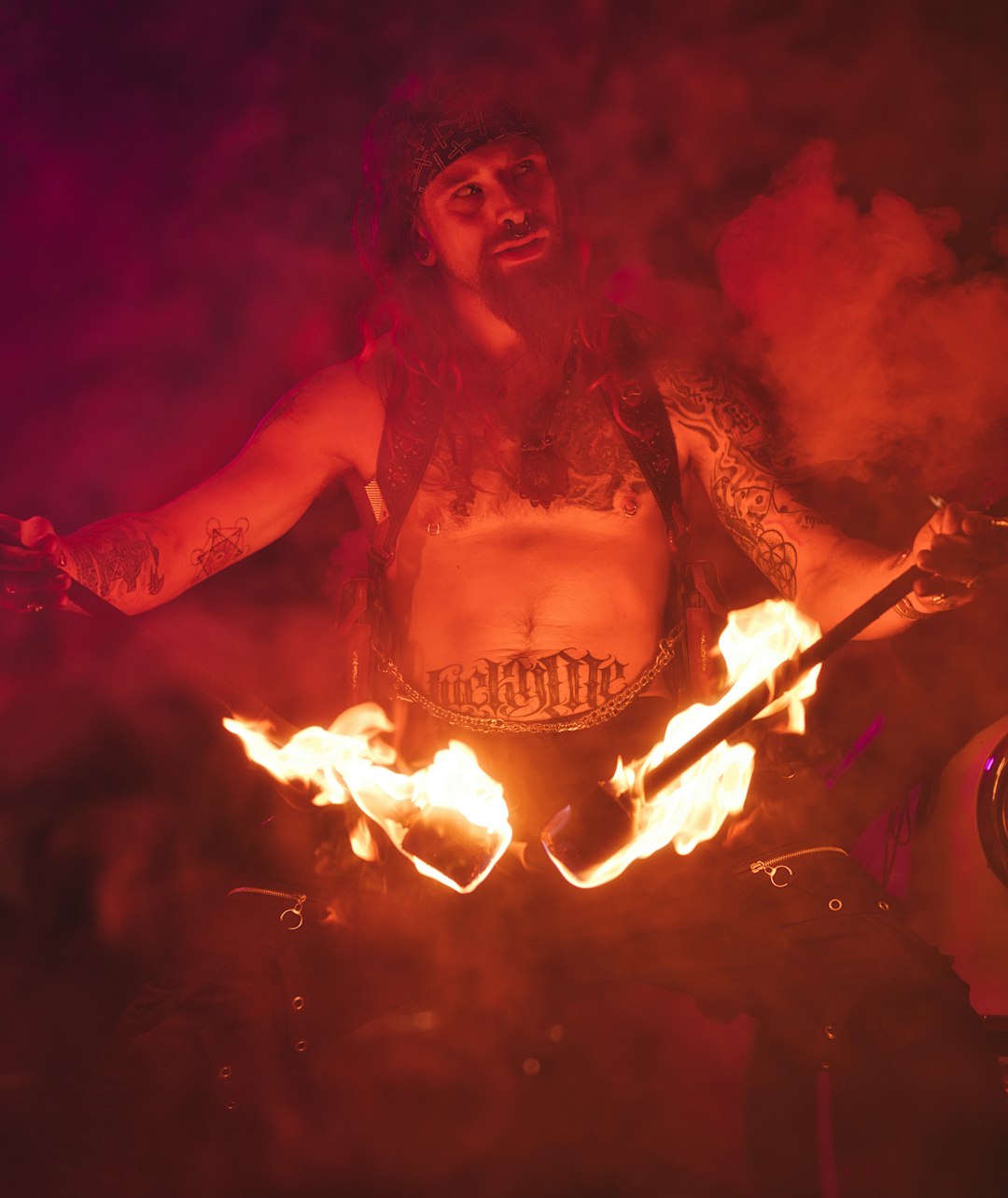 man in black tank top holding fire