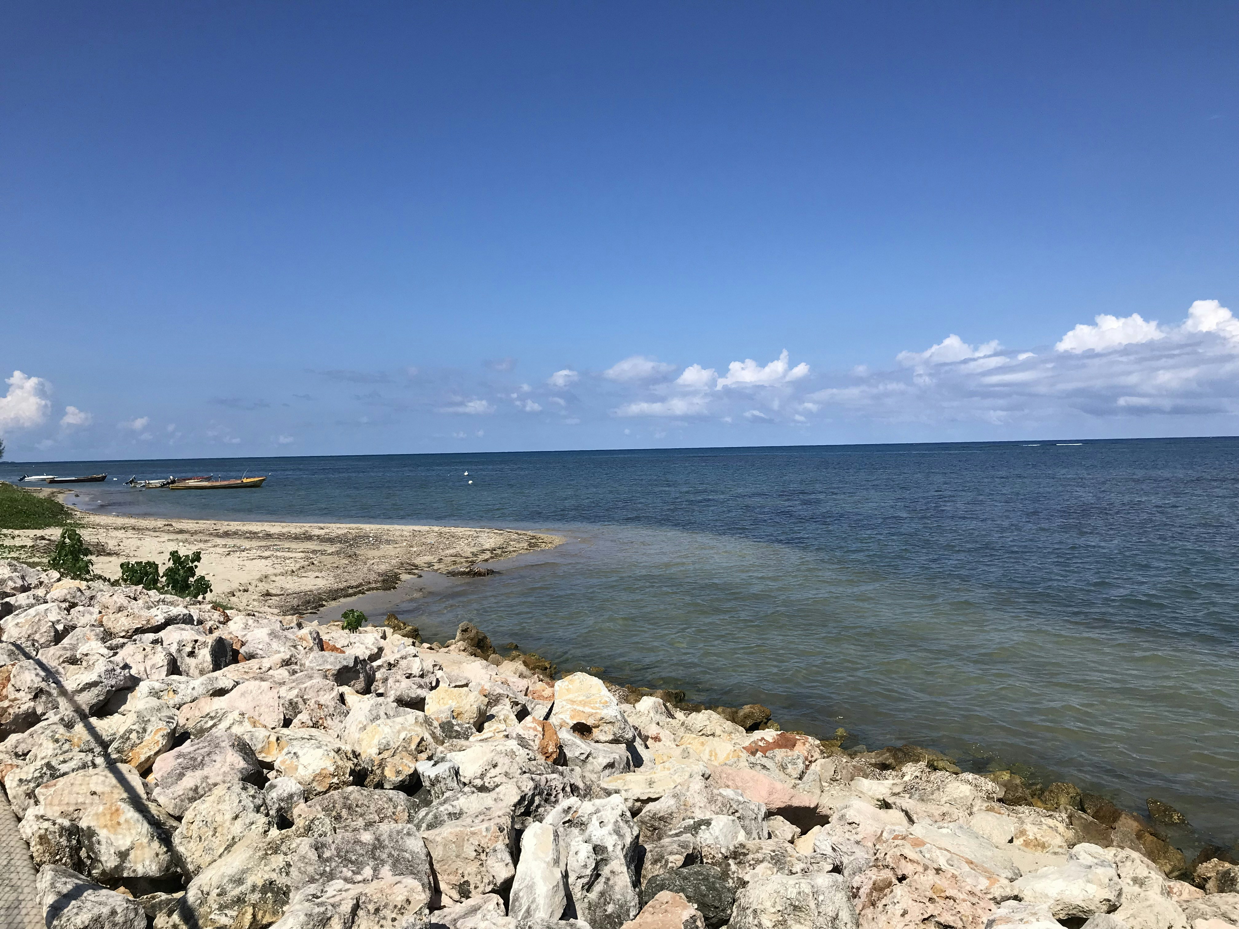 white and gray rocks near body of water during daytime