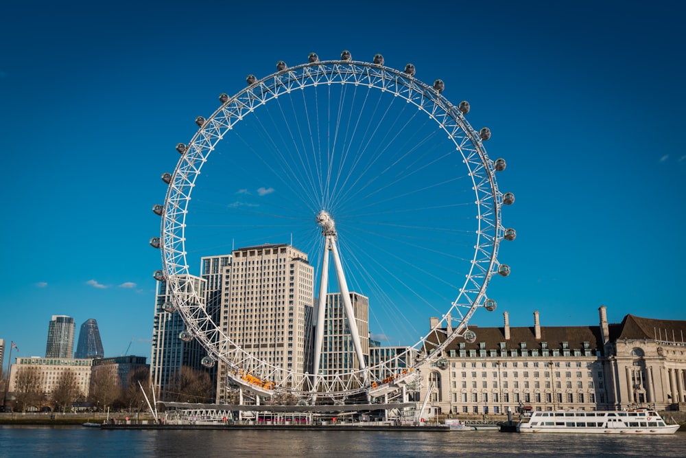 ferris wheel near body of water during daytime