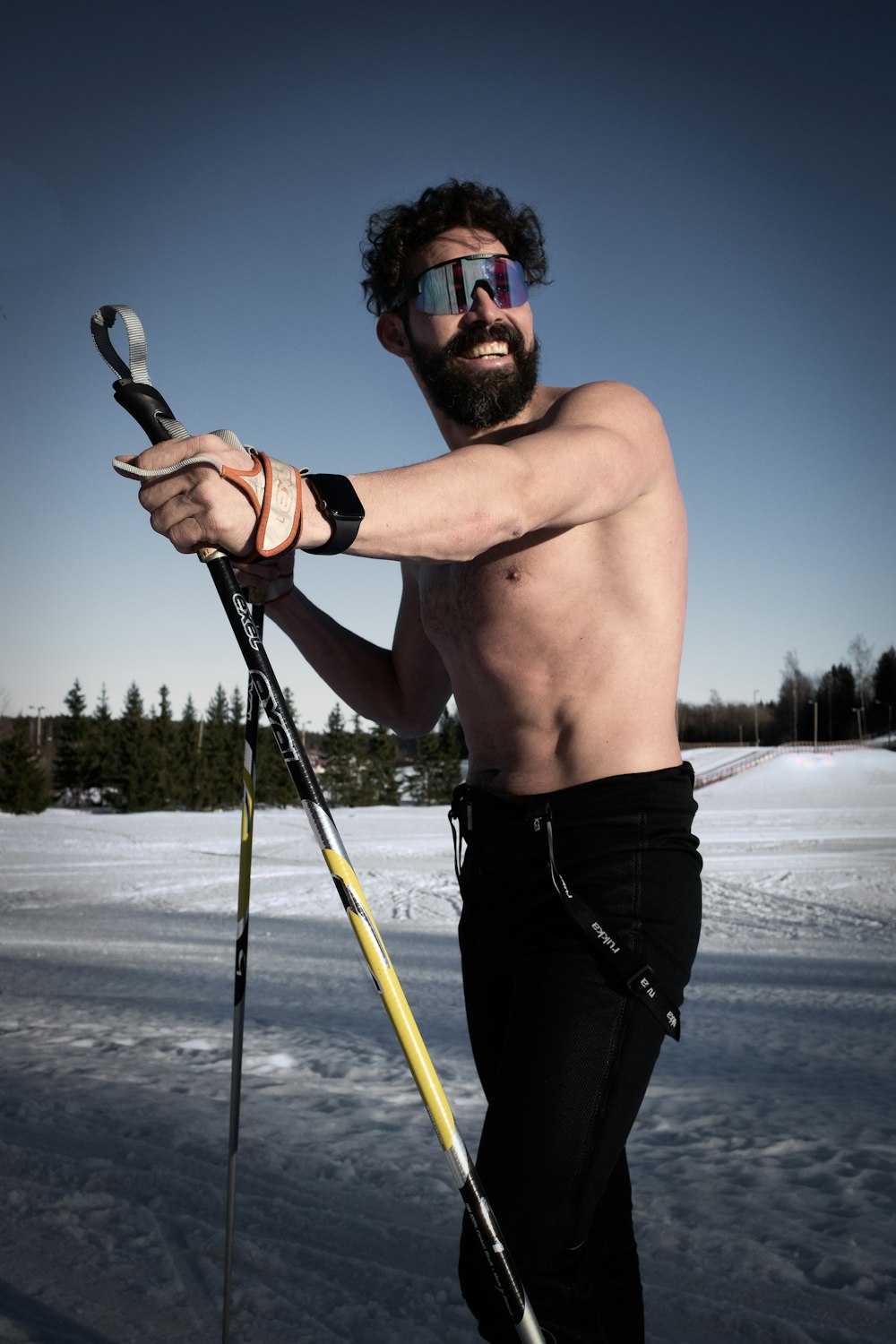 man in black shorts holding black and yellow ski pole