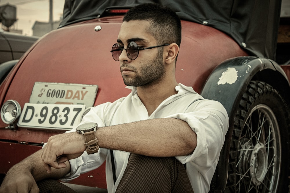 man in white polo shirt wearing black sunglasses