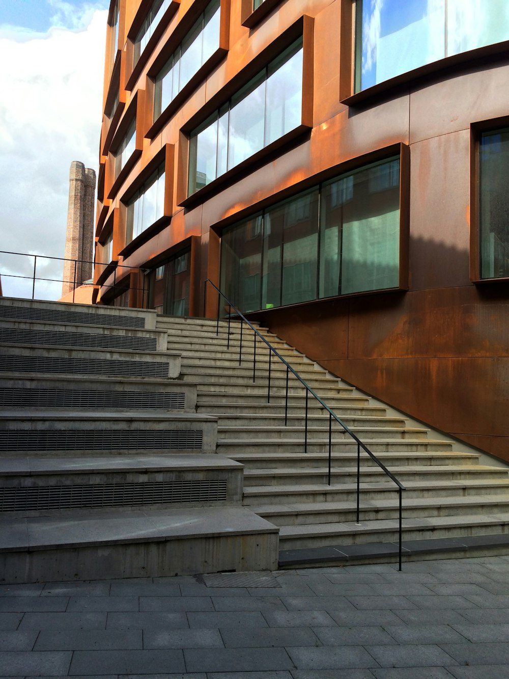스테인레스 스틸 난간이 있는 갈색 콘크리트 계단