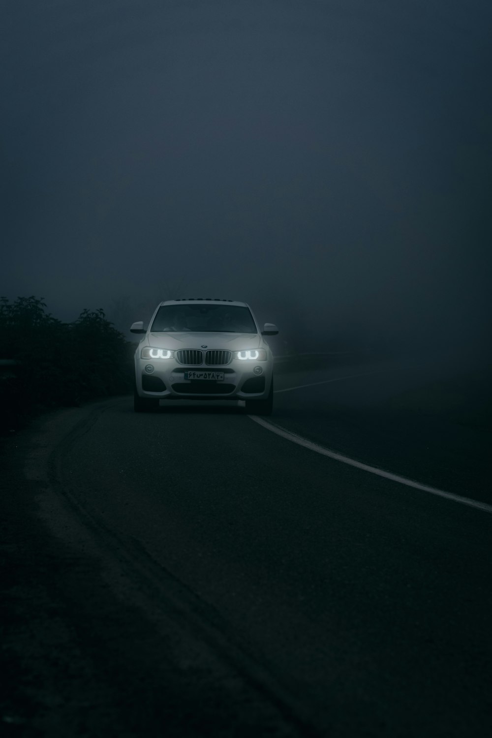 white car on road during night time