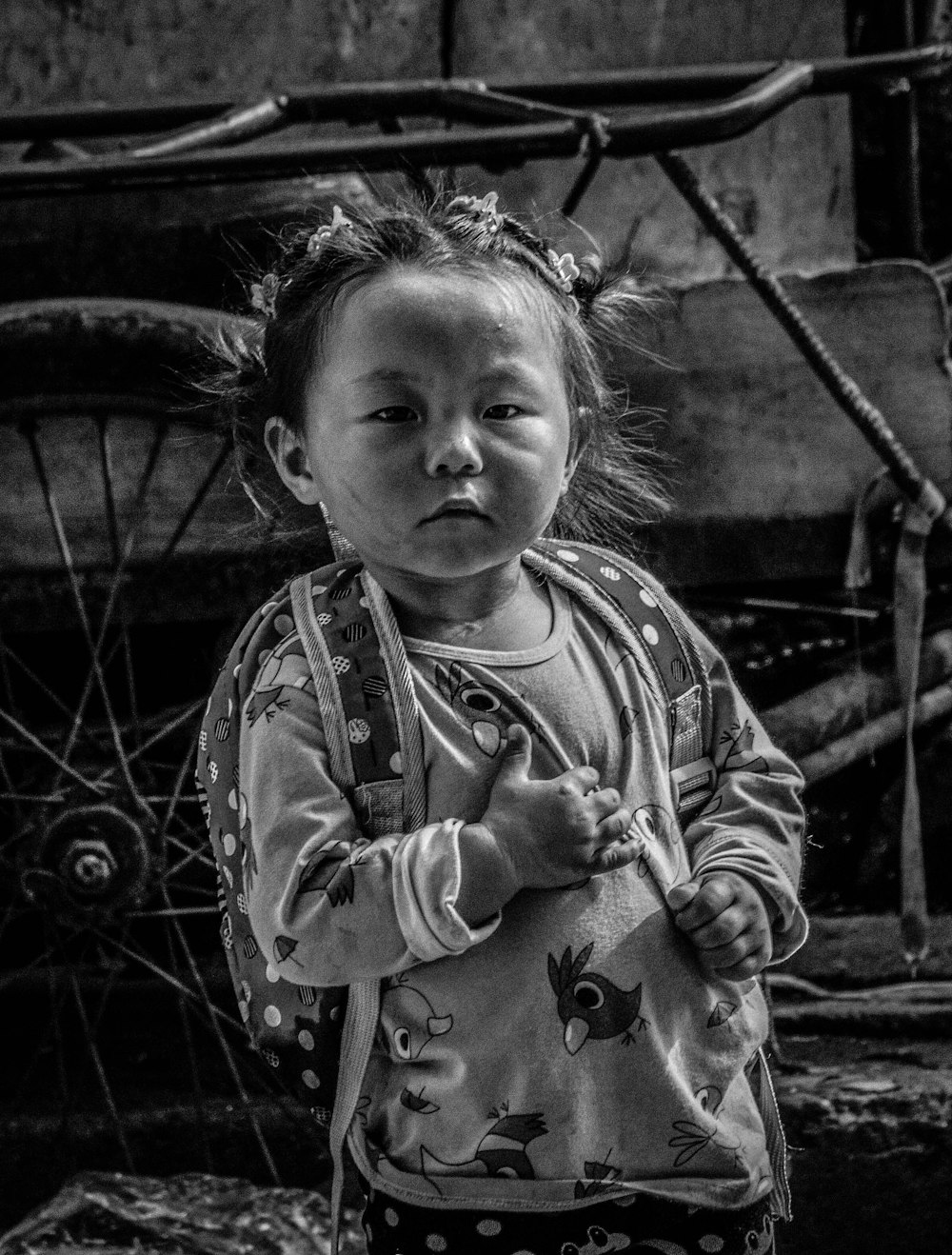 grayscale photo of child in long sleeve shirt