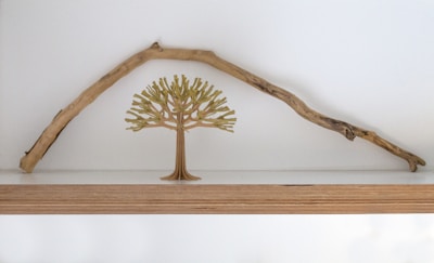 Elegant wooden home decor pieces arranged on a minimalist shelf.