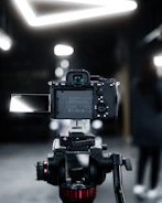 Behind-the-scenes shot of influencers unboxing and testing new camera gear.