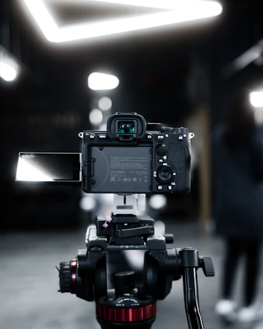 A focused YouTube reviewer filming a product demo with professional lighting and camera setup.