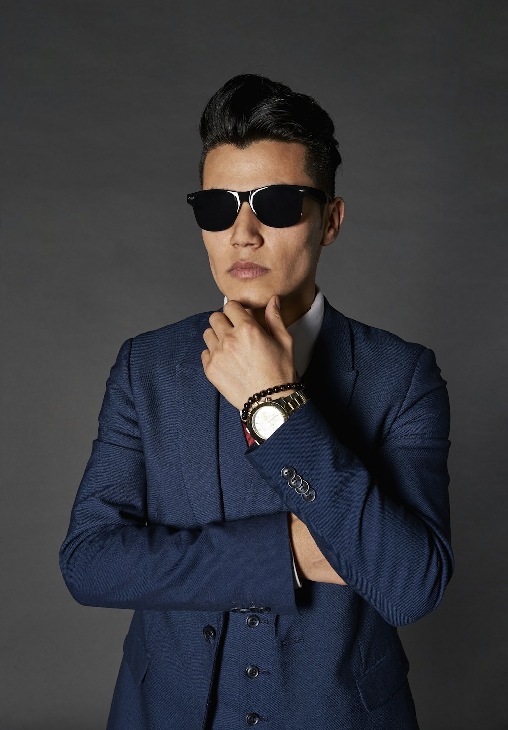 man in blue suit wearing black sunglasses
