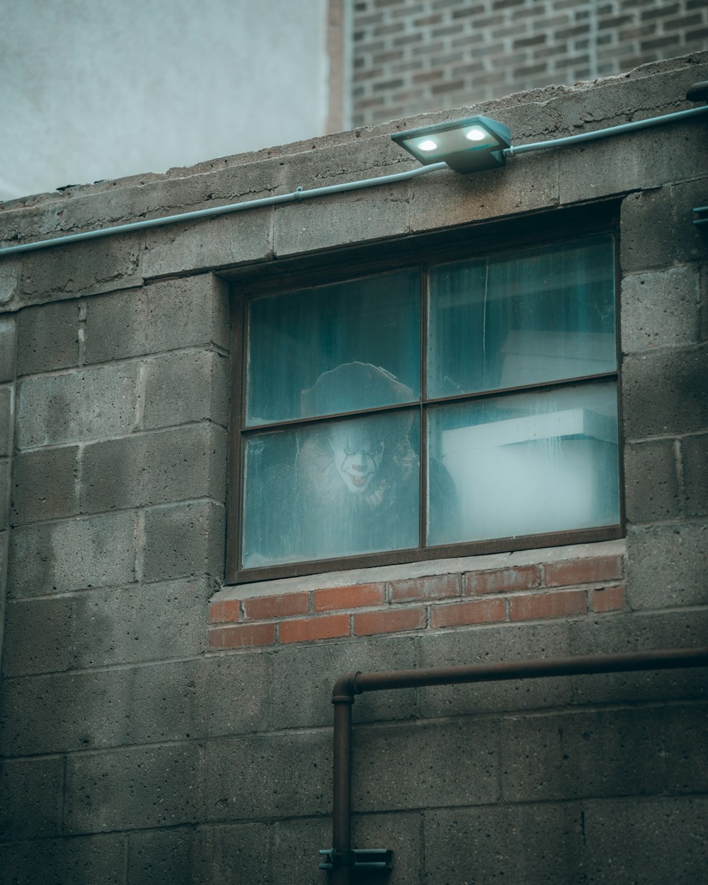 white framed glass window on gray concrete wall