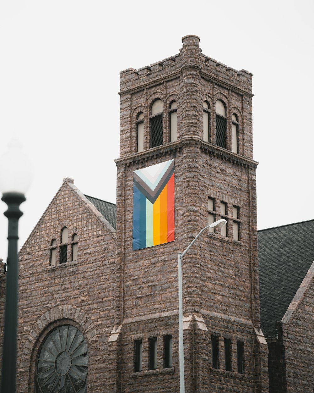 brown brick building with yellow and red windows