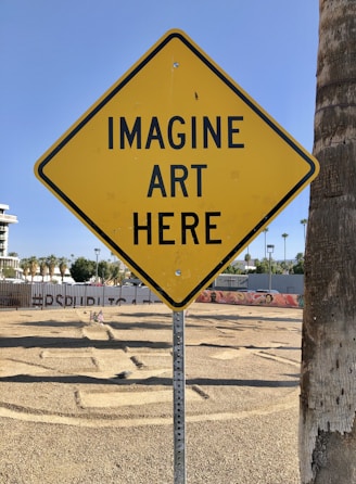 a yellow sign that says imagine art here