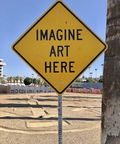 a yellow sign that says imagine art here