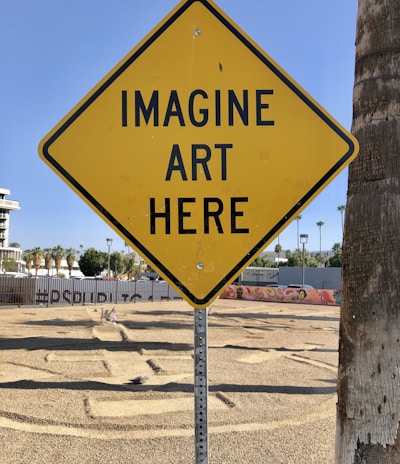 a yellow sign that says imagine art here