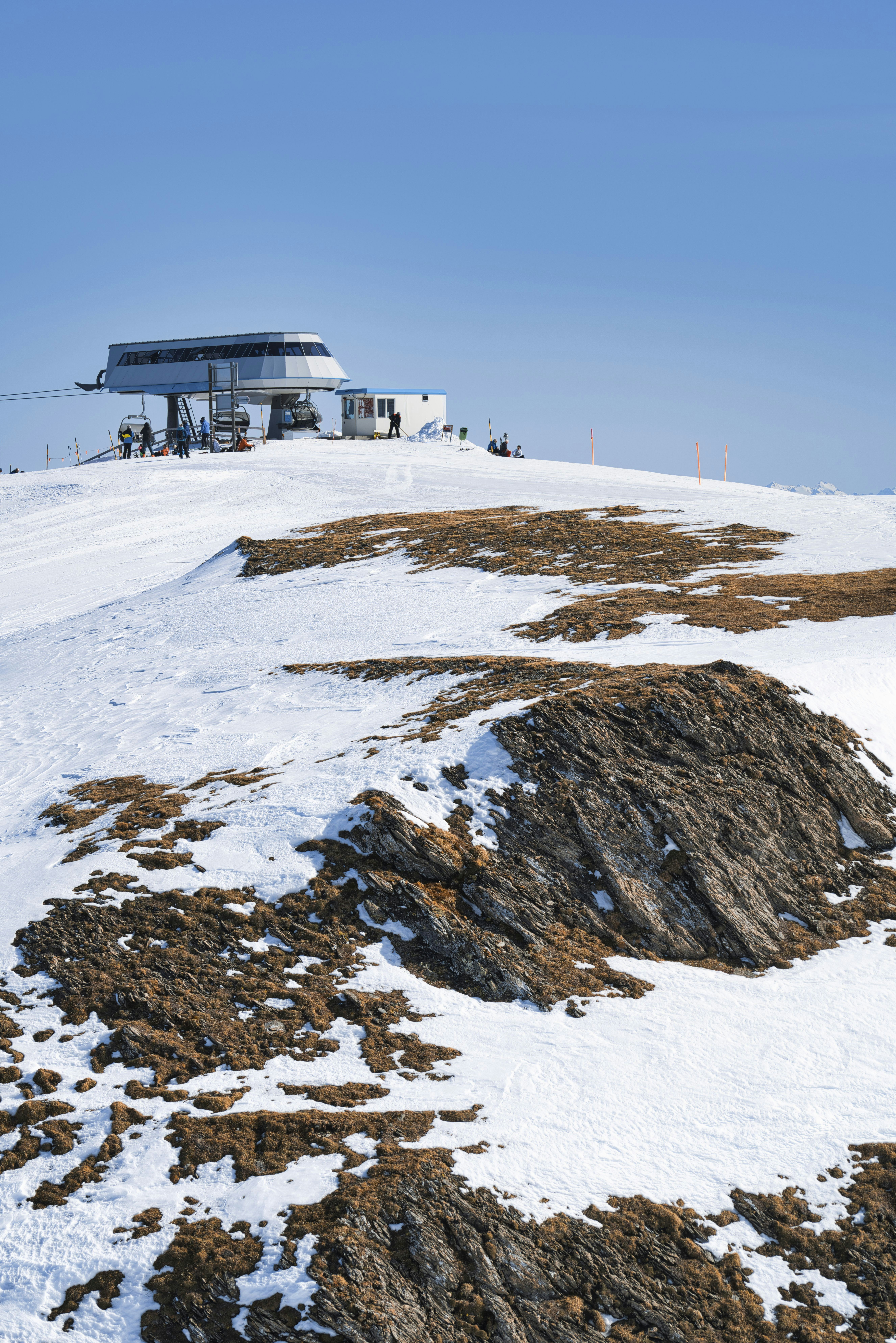 white and brown house on snow covered ground under blue sky during daytime