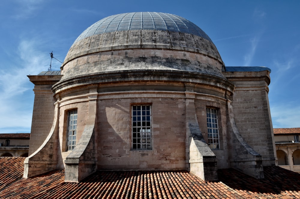 brown and white concrete building under blue sky during daytime