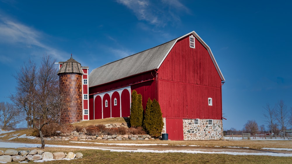 red wooden barn under blue sky during daytime