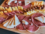 sliced meat on brown wooden chopping board
