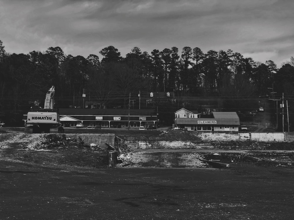 grayscale photo of man standing on dock