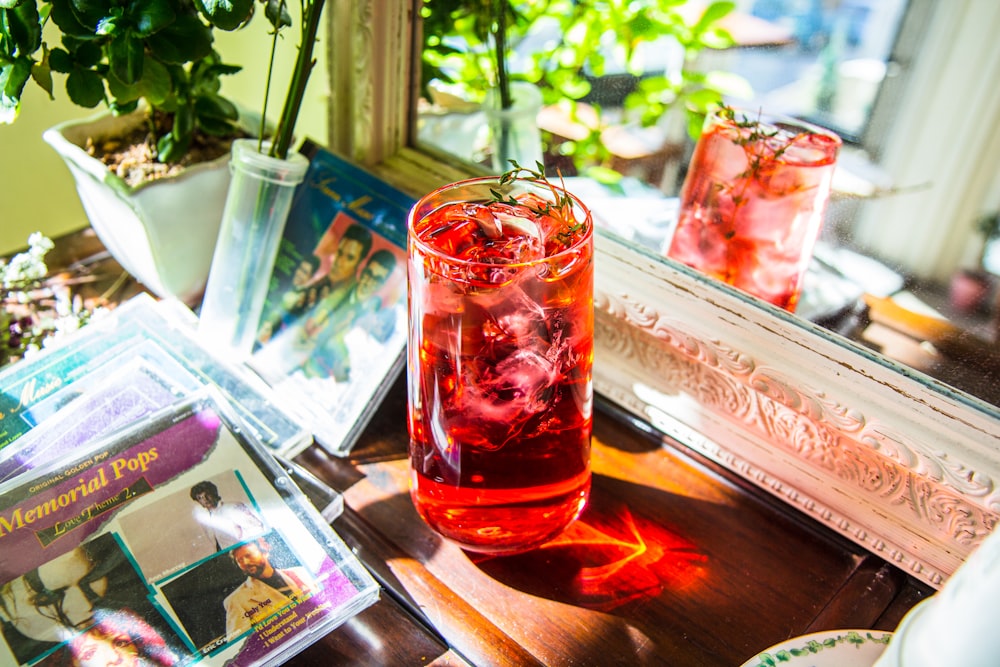 clear drinking glass with red liquid inside