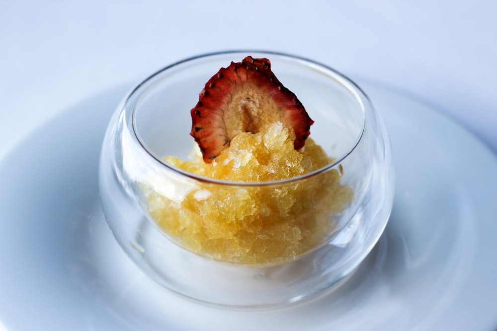 clear glass bowl with yellow and red ice cream