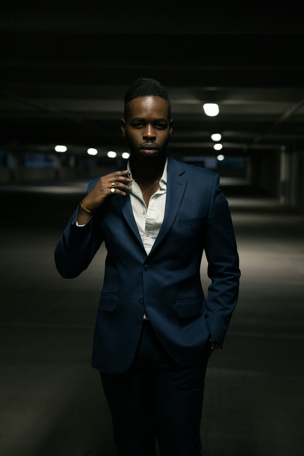 man in black suit jacket holding smartphone