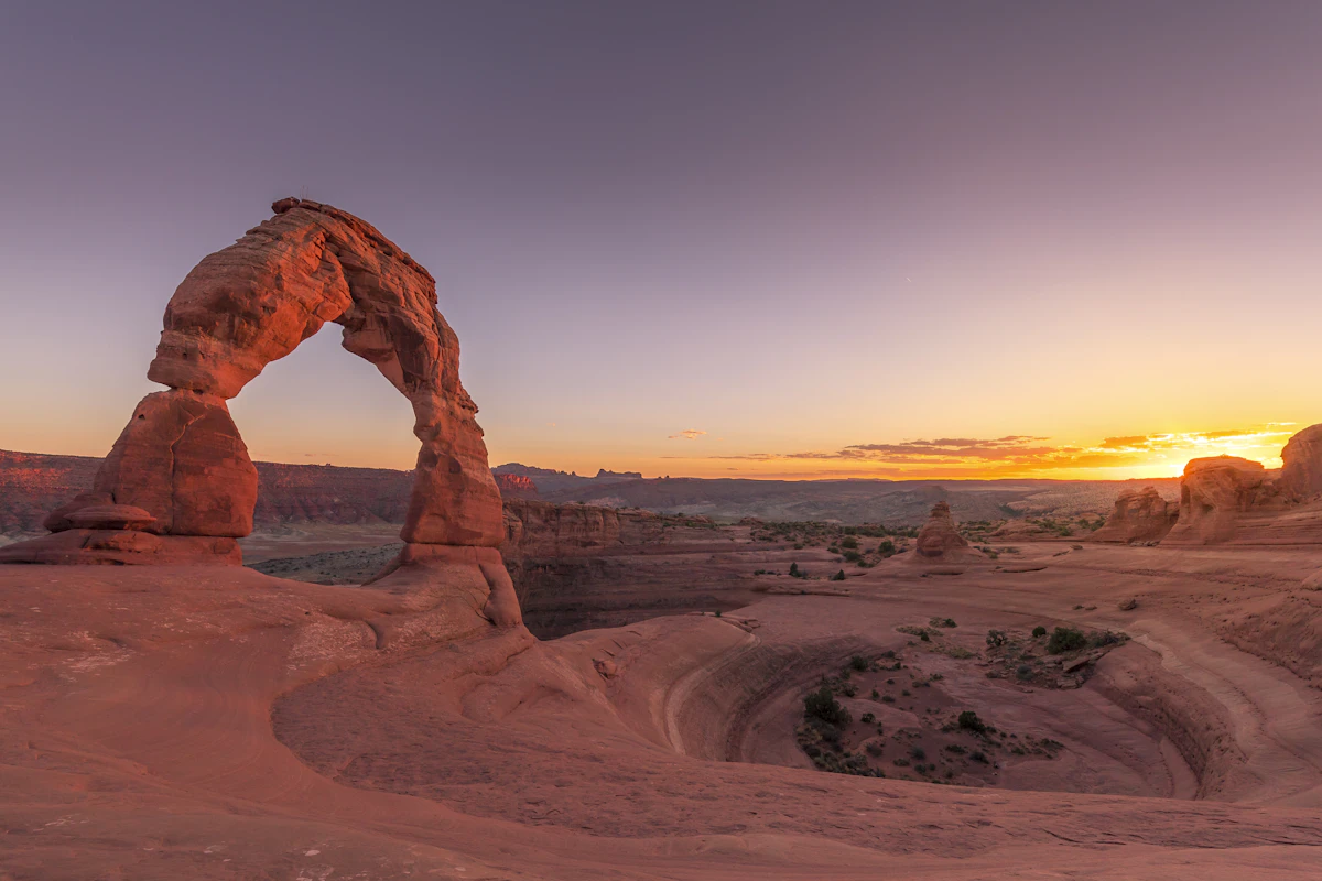 Delicate Arch glowing red at sunset in Arches National Park near Moab, Utah