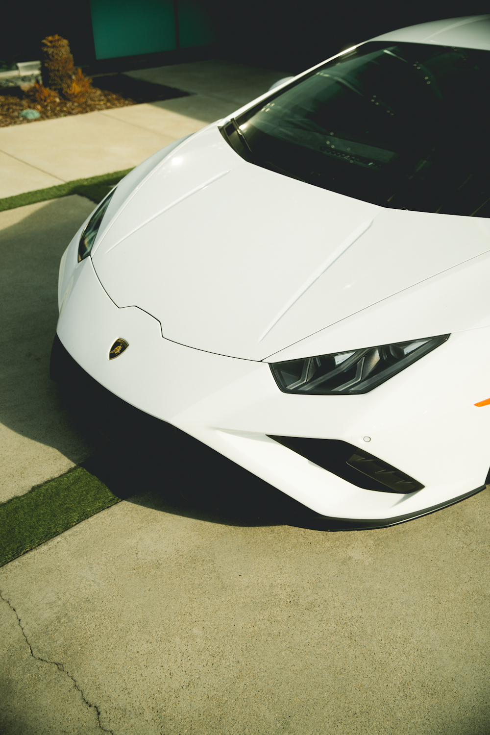 white lamborghini aventador parked on gray concrete road during daytime