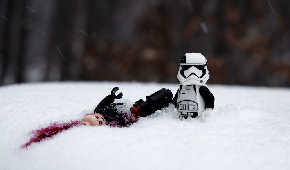 person in black and white helmet on snow covered ground during daytime