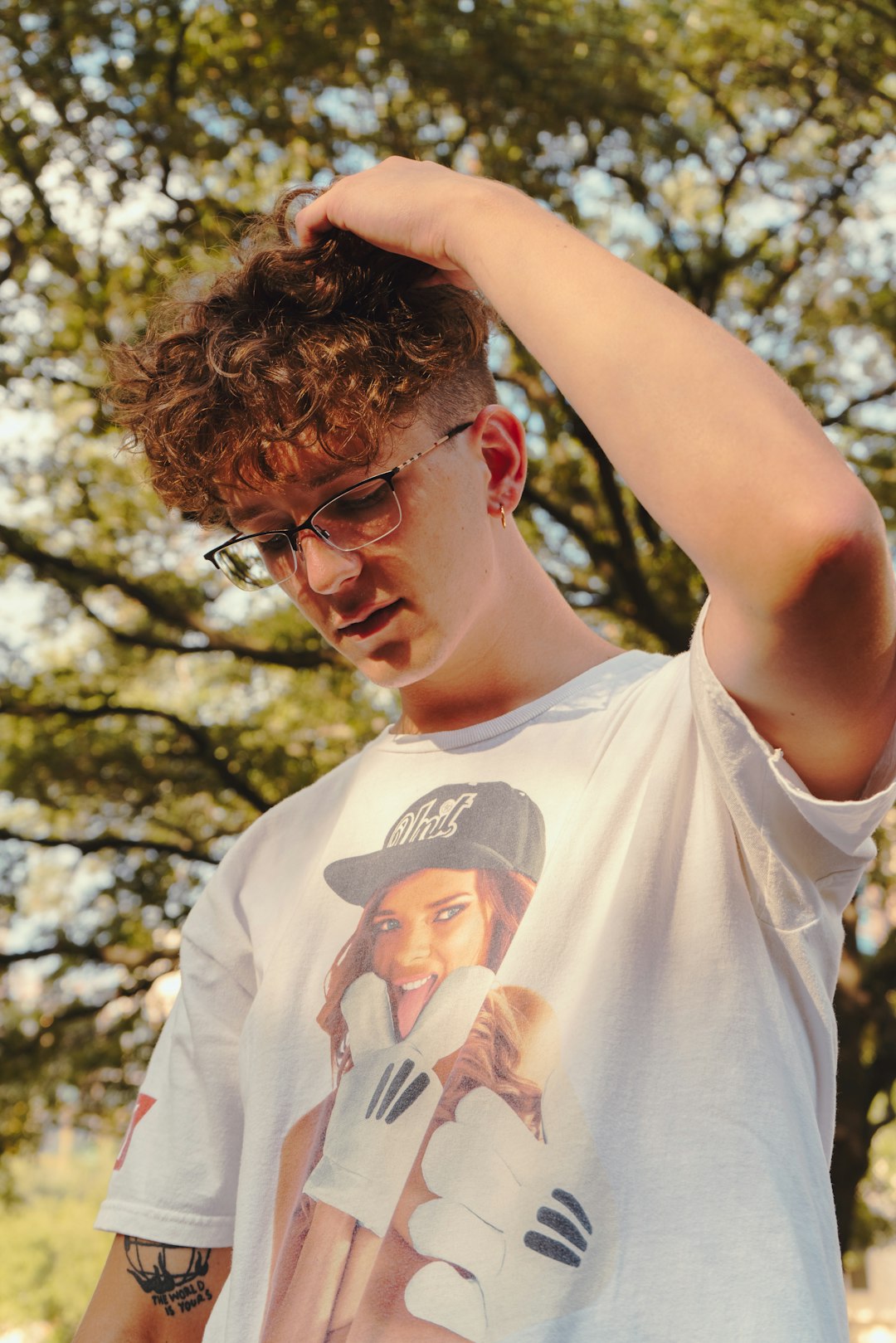 man in white crew neck t-shirt with black framed eyeglasses