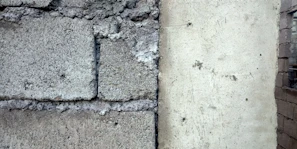 Side-by-side comparison of a building's foundation before and after sealing