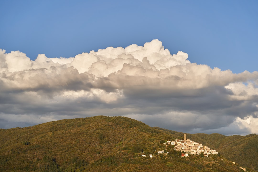 white clouds over green mountain