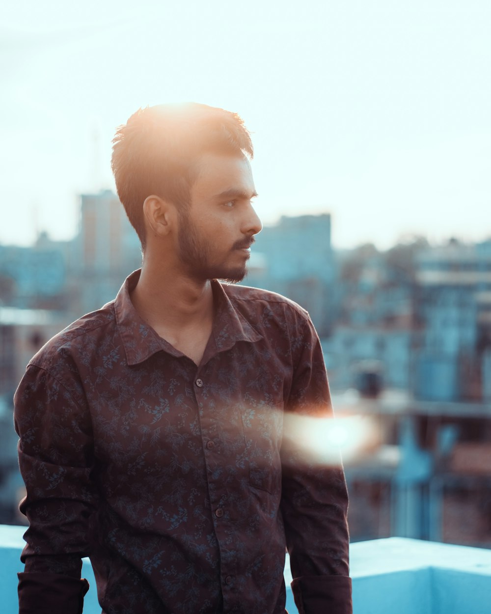 man in black dress shirt standing during daytime