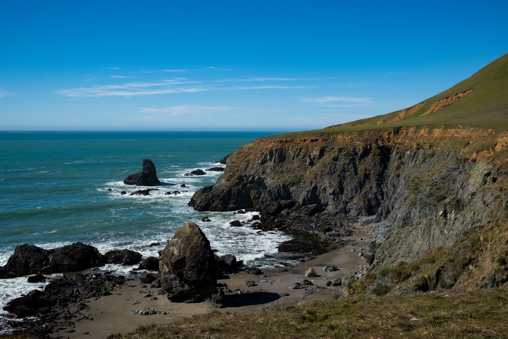 brown rock formation on sea shore during daytime