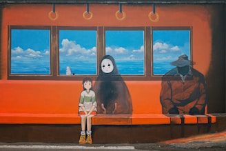 2 women standing beside black and white penguin statue