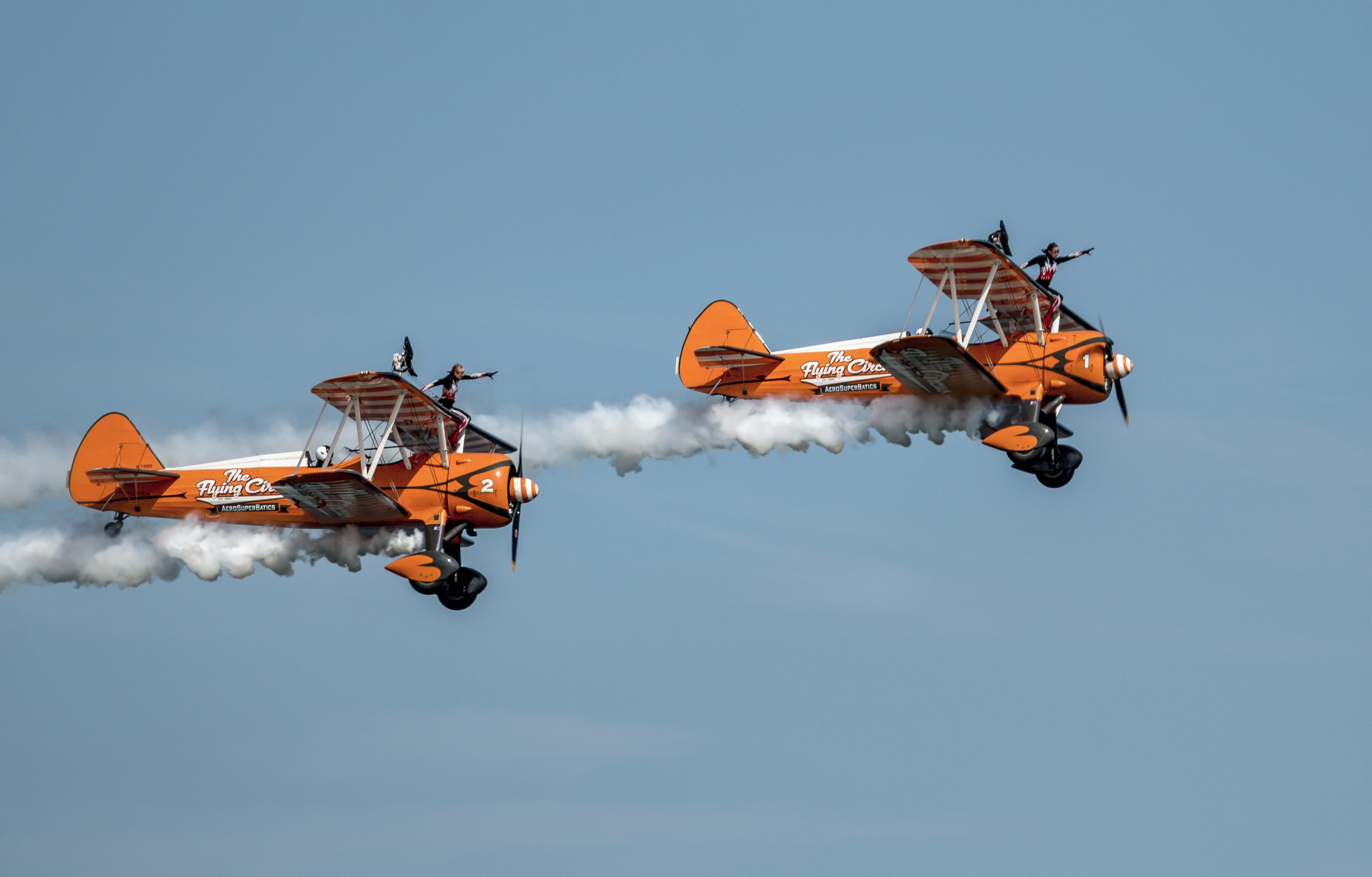 orange and white jet plane in mid air