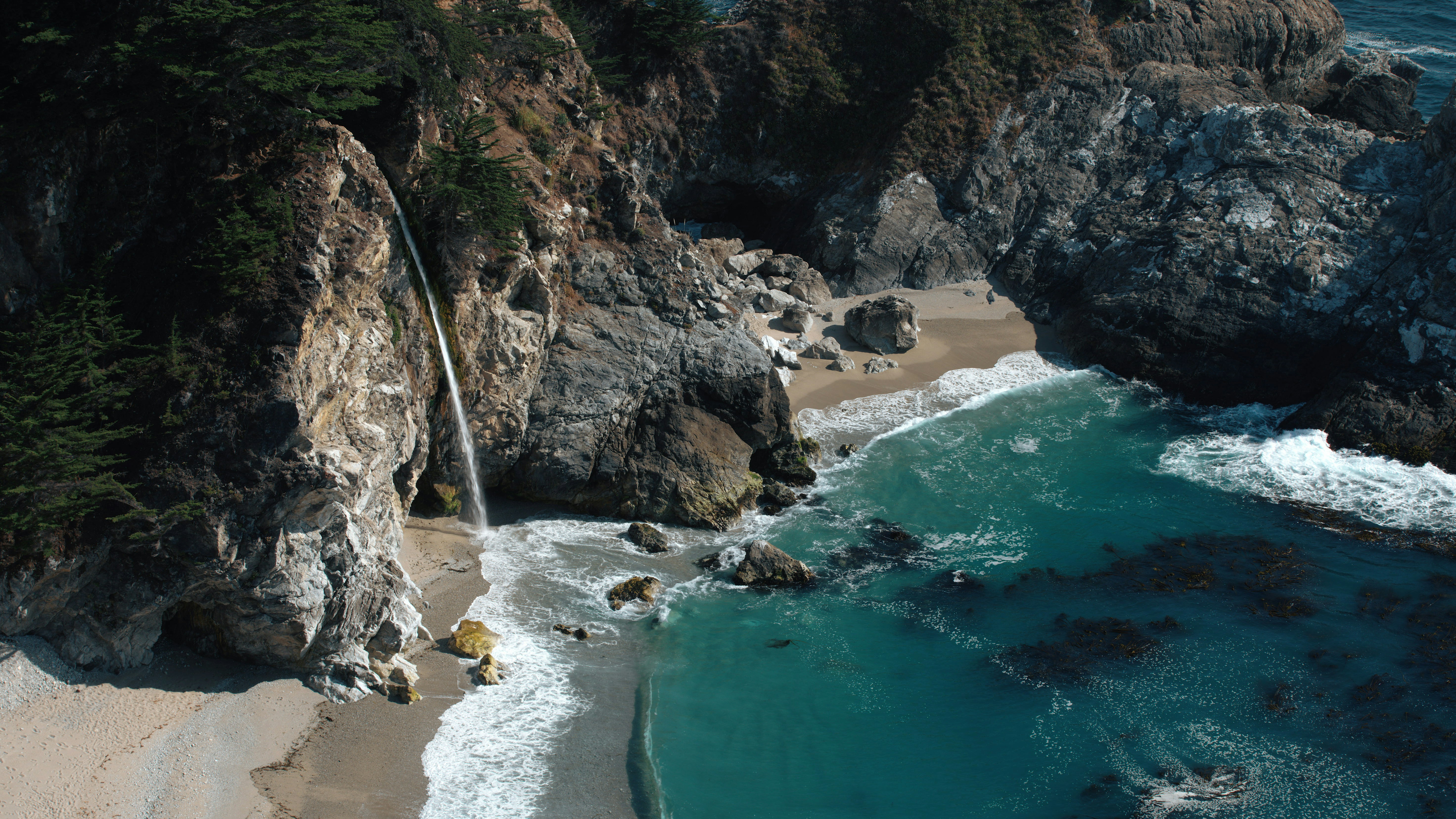 rocky shore with green water and brown rock formation