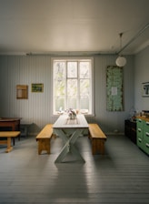 brown wooden table near window