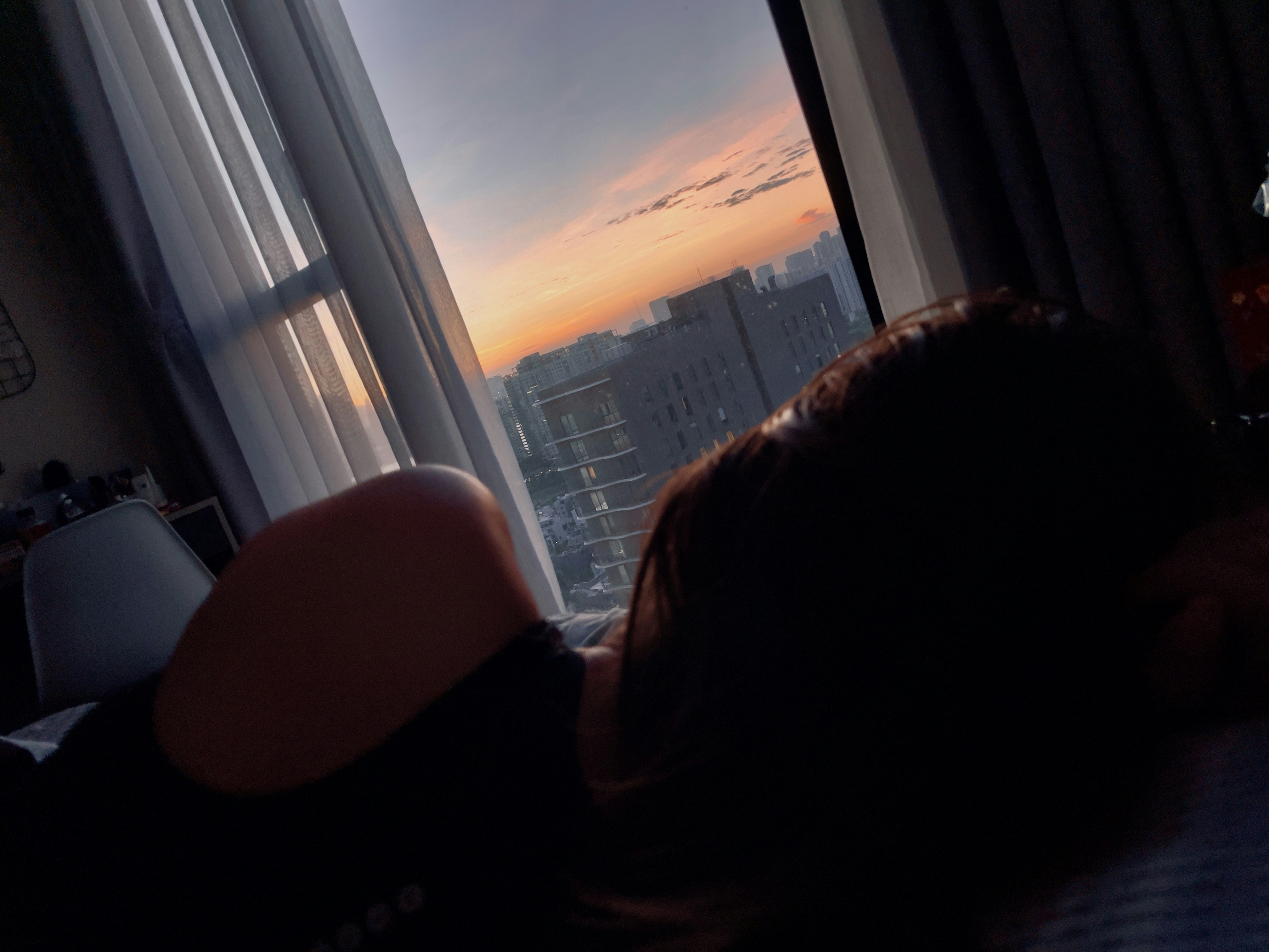 person sitting on chair near window during daytime