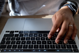 A tech entrepreneur confidently wearing the mf ring while working on a laptop.